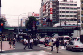 A Series 300 shinkansen train crosses a Tokyo street