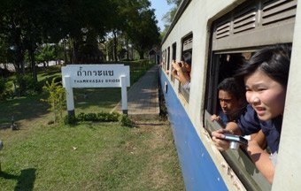 A train from Nam Tok to River Kwai Bridge, Kanchanaburi & Bangkok calls at Thamkrasae Bridge station
