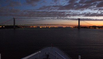At the end of a transatlantic crossing, the Queen Mary 2 approaches the Varrazano Narrows suspension bridge