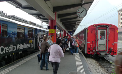 The Bernina Express leaves Tirano through the streets