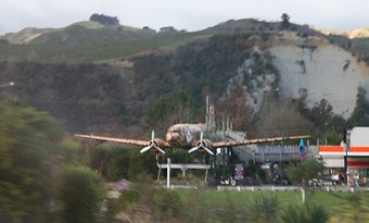 The Wellington-Auckland Overlander train passes the 'Cookie Time' DC3