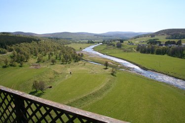 Crossng a wide green valley on the Highland Line south of Inverness