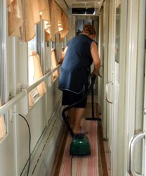 Hoovering the carpet in the train corridor