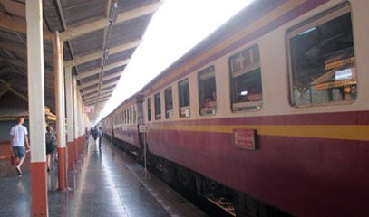 Exterior of older non-air-con carriages on a Thai express train