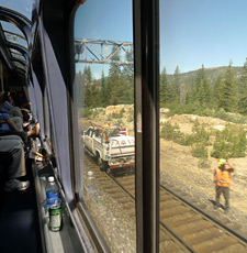 The train passes a track maintenance crew.